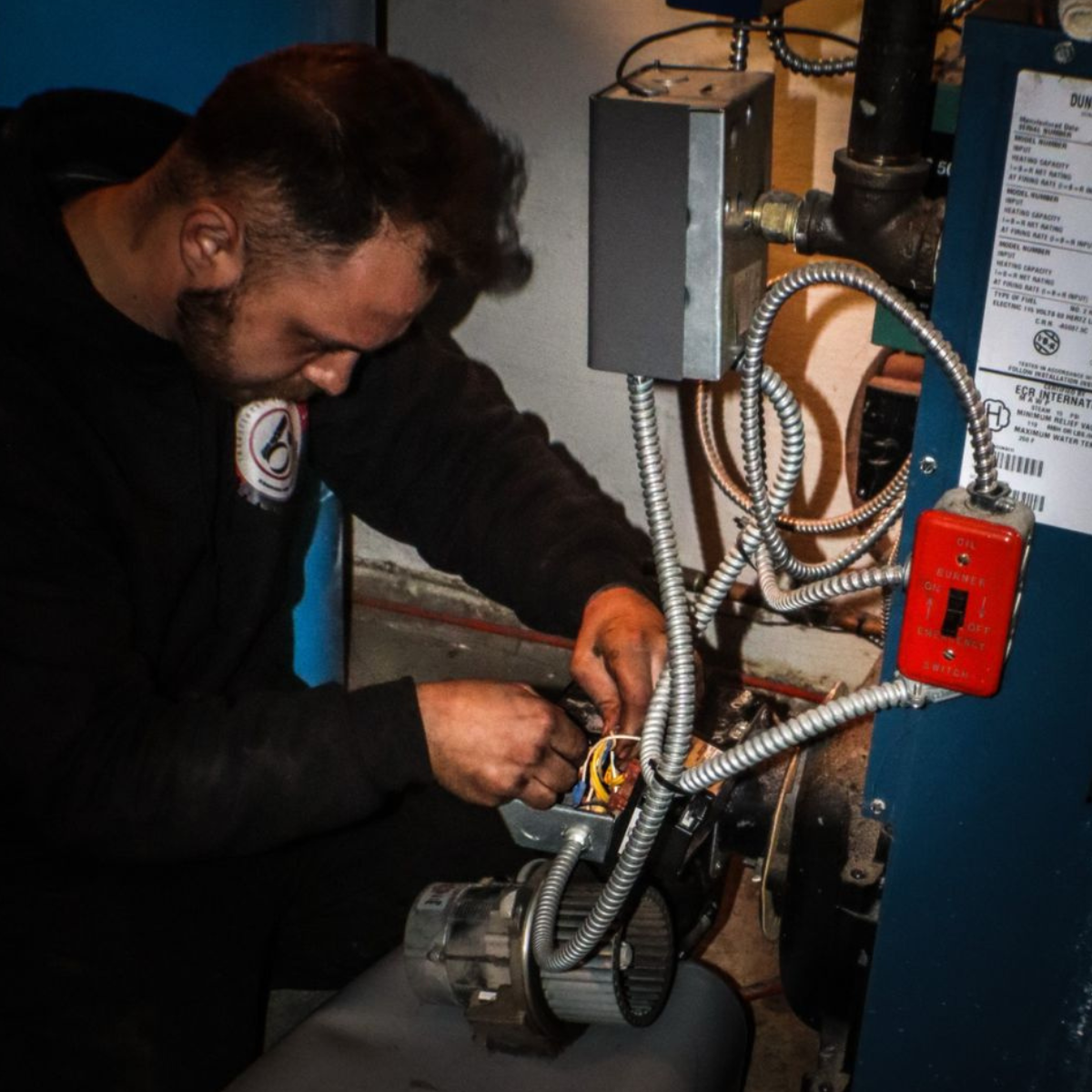 Heating contractor Ryan Donegan working on a heating system